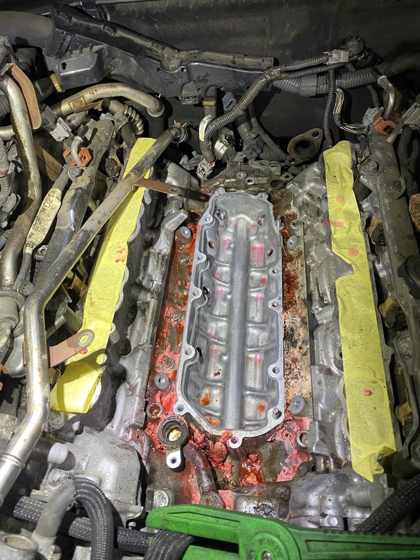 The GX460 valley plate after draining, surrounded by dried pink coolant crust
